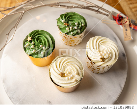 Delicious Christmas cupcakes with festive decorations Delicious Christmas cupcakes with festive decorations 121089998