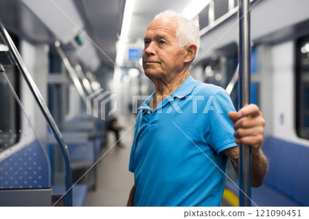Elderly man in subway train Elderly man in subway train 121090451