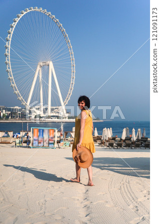 A Radiant Woman in a Yellow Dress Striding Towards the Beach, Gracefully Carrying a Straw Hat, Embracing the Warmth of the Sun and the Serenity of the Waves, Ready for a Day of Relaxation and Joy by A Radiant Woman in a Yellow Dress Striding Towards the Beach, Gracefully Carrying a Straw Hat, Embracing the Warmth of the Sun and the Serenity of the Waves, Ready for a Day of Relaxation and Joy by 121091173