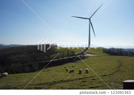 A huge wind turbine with beautiful nature as a background 121091363