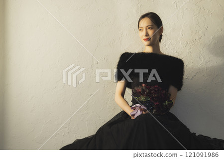 A woman in a black dress 121091986