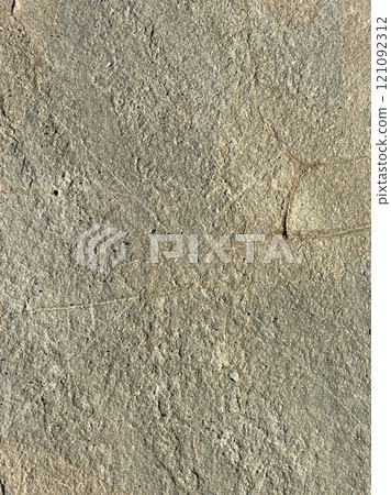 Natural texture of weathered stone surface in bright sunlight at outdoor location 121092312