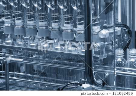 The empty drinking water bottles on the conveyor belt for filling process. The empty drinking water bottles on the conveyor belt for filling process. 121092499