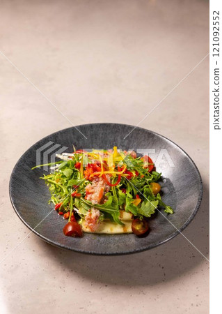 Gourmet salad with smoked salmon and avocado on a modern plate Gourmet salad with smoked salmon and avocado on a modern plate 121092552