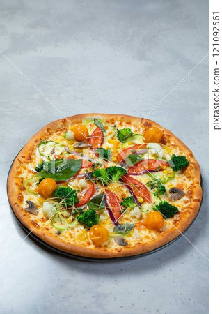 Delicious vegetarian pizza lying on gray table background Delicious vegetarian pizza lying on gray table background 121092561