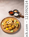 Appetizing deep fried platter served with variety of dipping sauces 121092614
