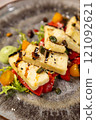 Delicious grilled halloumi cheese salad with a side of pesto sauce 121092621