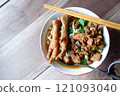 One bowl of traditional Indonesian chicken noodles. This food has a rich, spiced taste. 121093040
