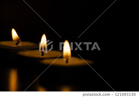 Candles shining in the dark with customizable space for message, text or ideas. Candles shining in the dark with customizable space for message, text or ideas. 121093130