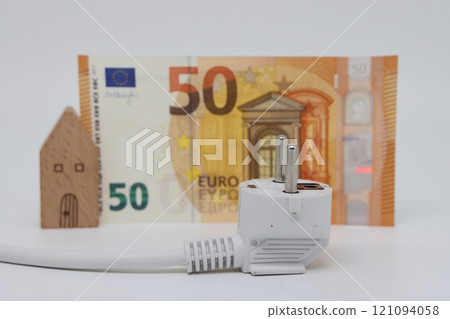 White electric cable and banknotes against the background of a toy model house White electric cable and banknotes against the background of a toy model house 121094058