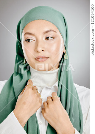 Closeup of beautiful muslim woman posing in a studio with a green hijab. Headshot of a stunning confident arab model isolated against a grey background. Zoomed in on young fashionable middle eastern Closeup of beautiful muslim woman posing in a studio with a green hijab. Headshot of a stunning confident arab model isolated against a grey background. Zoomed in on young fashionable middle eastern 121094100