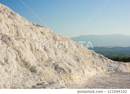 Cotton castle area with carbonate mineral after flowing thermal spring water. Landscape of travertine pools and terraces in Pamukkale Turkey. Traveling abroad, overseas for holiday, vacation, tourism Cotton castle area with carbonate mineral after flowing thermal spring water. Landscape of travertine pools and terraces in Pamukkale Turkey. Traveling abroad, overseas for holiday, vacation, tourism 121094102
