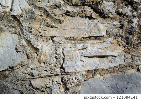 Closeup of ancient stone wall Background of rustic, rural building and masonry. Historic housing design concept of an urban structure outside with copyspace. Detail of antique architecture in village 121094141