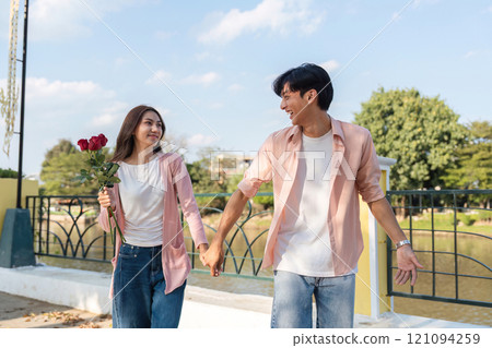 Valentine's day romantic stroll park lifestyle imagery daylight couple holding hands love story 121094259
