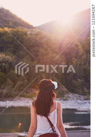 Hiking, mountain and virtual reality with woman in nature for metaverse adventure, journey or travel. Back, earth and forest with tourist person in VR headset for holiday or vacation user experience 121094267
