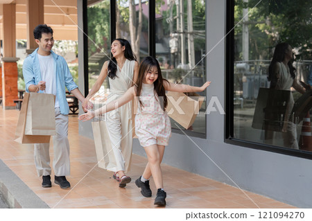 Family shopping day urban mall candid moments bright environment joyful viewpoint togetherness concept 121094270