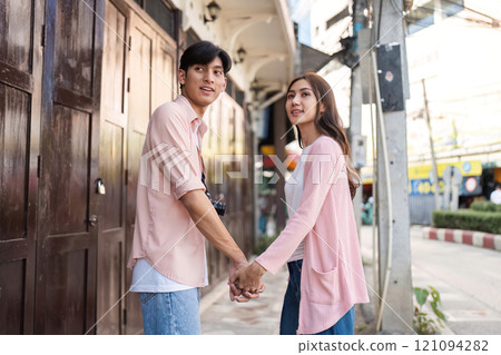 Valentine's day celebration urban street couple holding hands vibrant atmosphere romantic viewpoint love concept 121094282