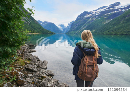 Adventure backpacking woman enjoying view of majestic mountain lake explore travel discover beautiful earth Adventure backpacking woman enjoying view of majestic mountain lake explore travel discover beautiful earth 121094284