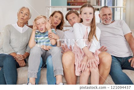 Portrait of a happy family sitting on the couch and making funny faces in the living room at home. Joyful little girl and boy bonding with parents and grandparents in the living room Portrait of a happy family sitting on the couch and making funny faces in the living room at home. Joyful little girl and boy bonding with parents and grandparents in the living room 121094437