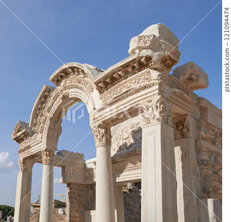 Historical Turkey Ephesus arch in an ancient city. A keystone arch with architectural detail and patterns. Tourist attraction of ancient remains of a temple building in Turkish history and culture Historical Turkey Ephesus arch in an ancient city. A keystone arch with architectural detail and patterns. Tourist attraction of ancient remains of a temple building in Turkish history and culture 121094474