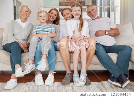 Portrait of a happy family sitting on the couch in the living room at home. Joyful little girl and boy bonding with parents and grandparents in the living room. Grandparents visiting grandchildren Portrait of a happy family sitting on the couch in the living room at home. Joyful little girl and boy bonding with parents and grandparents in the living room. Grandparents visiting grandchildren 121094494
