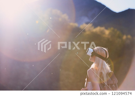 Earth, virtual reality and water with woman in nature for metaverse adventure, journey or travel. Forest, hiking and mountain with tourist person in VR headset for holiday or vacation user experience 121094574