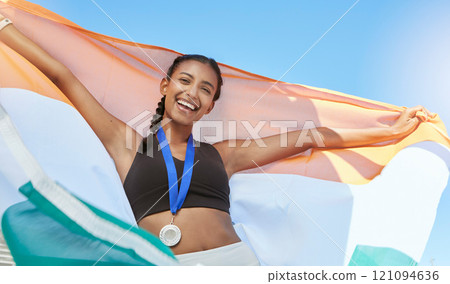 Portrait of a young fit indian female athlete cheering and holding India flag after competing in sports. Smiling fit active sporty woman feeling motivated and celebrating Portrait of a young fit indian female athlete cheering and holding India flag after competing in sports. Smiling fit active sporty woman feeling motivated and celebrating 121094636