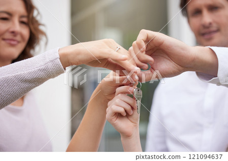 Closeup hands of happy married couple holding up house keys. Man and woman holding keys to new house or apartment. Young family buying or renting new house and moving in together, loan or mortgage Closeup hands of happy married couple holding up house keys. Man and woman holding keys to new house or apartment. Young family buying or renting new house and moving in together, loan or mortgage 121094637