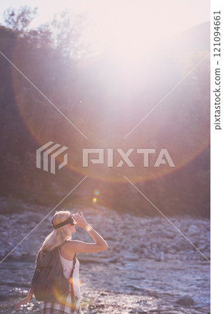 Hiking, virtual reality and water with woman in nature for metaverse adventure, journey or travel. Earth, forest and mountain with tourist person in VR headset for holiday or vacation user experience 121094661