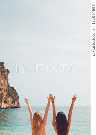 Back, freedom or celebration of friends at sea on holiday, tourist vacation or summer mockup space. Rear view, women and girls at ocean, water or travel outdoor together in tropical nature or horizon Back, freedom or celebration of friends at sea on holiday, tourist vacation or summer mockup space. Rear view, women and girls at ocean, water or travel outdoor together in tropical nature or horizon 121094697