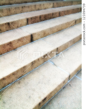 A closeup of a staircase. Details of an empty stairway outside in an urban city or town. Wide solid stairs found in commercial or big residential buildings. Light textures on stony or concrete steps A closeup of a staircase. Details of an empty stairway outside in an urban city or town. Wide solid stairs found in commercial or big residential buildings. Light textures on stony or concrete steps 121094739