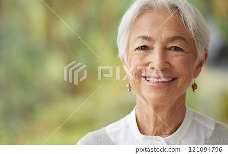 Smiling senior woman with copy space on the side. Portrait of a beautiful confident elderly female with grey hair. Face of a happy pensioner enjoying retirement. Relaxed wise lady feeling optimistic 121094796