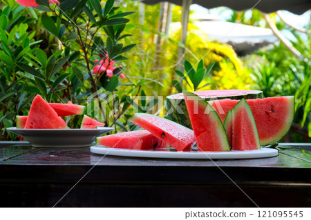 Slices of ripe watermelon on wooden table close up 121095545