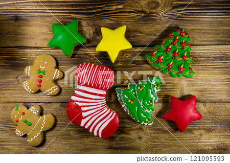 Festive tasty Christmas gingerbread cookies on wooden table. Top view 121095593