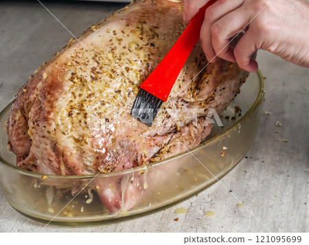 Raw goose being prepared for roasting 121095699