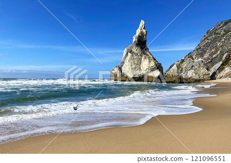 Empty wild sandy beach, Atlantic Ocean seascape, sea waves, beautiful cloudscape, dramatic landscape, travel content, Lisbon, Portugal 121096551