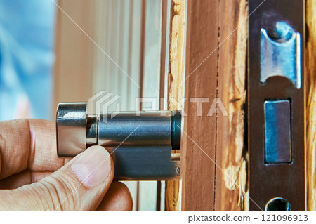 Built in cylinder of door mortise lock is inserted into housing of internal mechanism during installation. Built in cylinder of door mortise lock is inserted into housing of internal mechanism during installation. 121096913