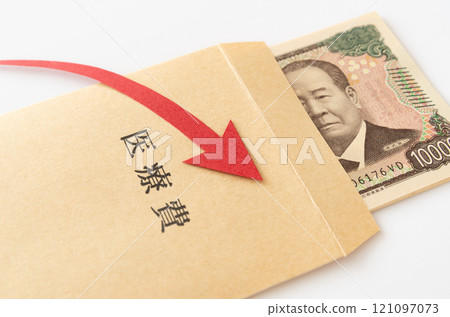 10,000 yen bill in an envelope for medical expenses and a downward arrow, paper money, expenditure, household finances 121097073