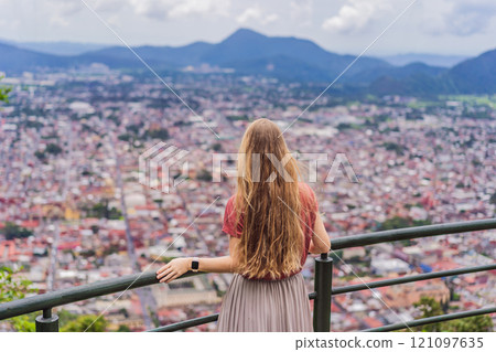 Female tourist in front of the panoramic view of Orizaba from Cerro del Borrego, Mexico. Travel, scenic landscape, and adventure concept Female tourist in front of the panoramic view of Orizaba from Cerro del Borrego, Mexico. Travel, scenic landscape, and adventure concept 121097635