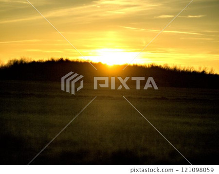 sunset over the field 121098059