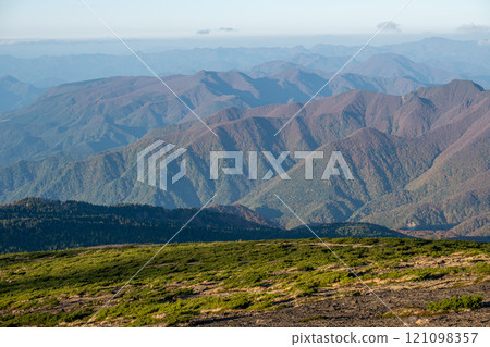 Zao mountain Yamagata Japan, Mountainous landscape under clear skies and distant peaks 121098357