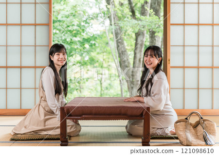 Young Asian woman on a girls trip to a ryokan or hot spring inn (travel, Japanese-style room, veranda) Young Asian woman on a girls trip to a ryokan or hot spring inn (travel, Japanese-style room, veranda) 121098610