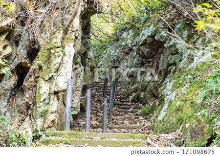 Ginzan onsen, Yamagata, Japan, Narrow pathway through rocky terrain with greenery. 121098675