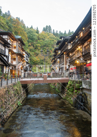 Ginzan onsen, Yamagata, Japan, Scenic riverside view with traditional buildings and bridge. 121098705