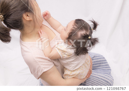 Baby touching grandma's face 121098767