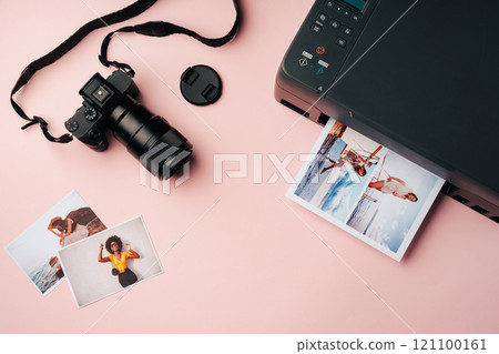 Printer and photo camera on table. Printing photos concept 121100161