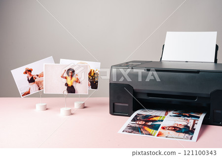 Modern laser printer printing color photos of women close up Modern laser printer printing color photos of women close up 121100343