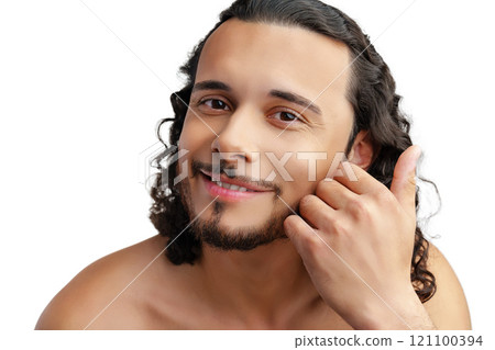 Young man with curly hair thoughtfully posing against a plain background 121100394