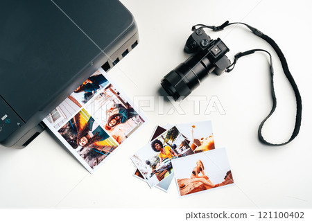 Printer and photo camera on table. Printing photos concept Printer and photo camera on table. Printing photos concept 121100402
