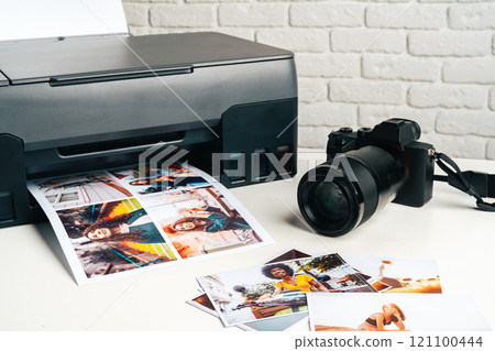 Printer and photo camera on table. Printing photos concept Printer and photo camera on table. Printing photos concept 121100444